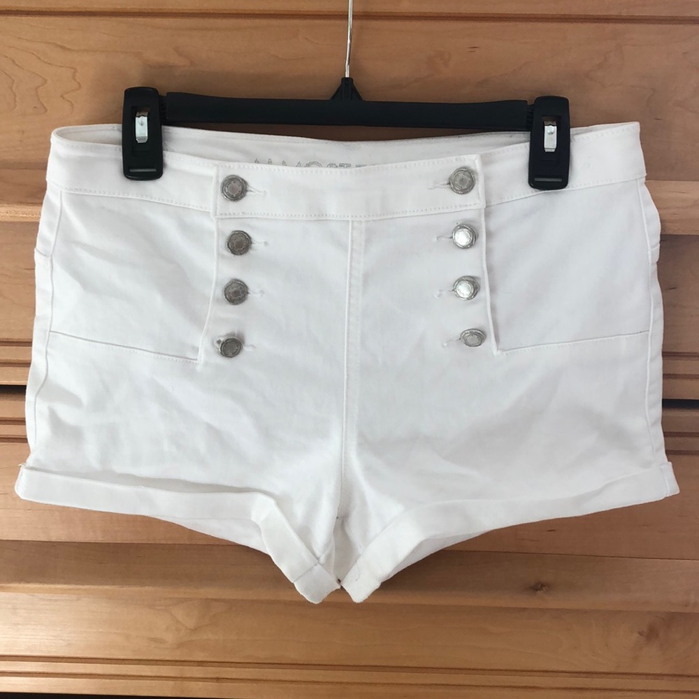 A pair of Almost Famous white button up shorts